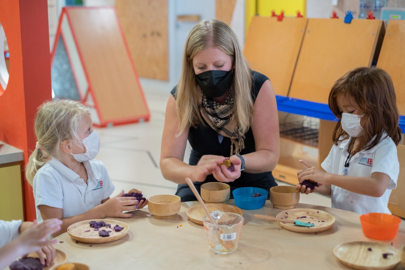 An HKA educator guiding primary students through a hands-on sensory learning activity at our inclusive international IB World School in Sai Kung.