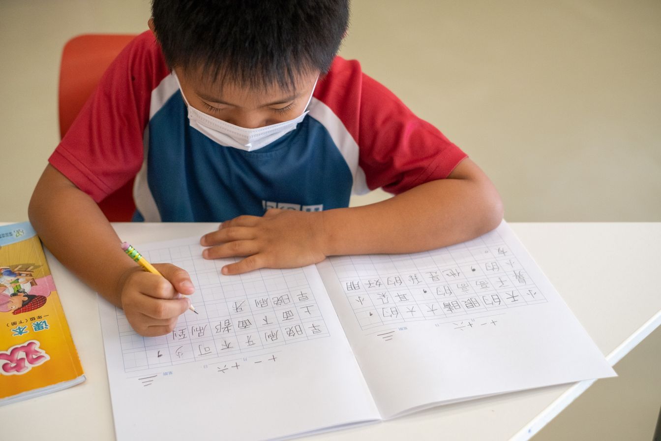 A primary student at Hong Kong Academy practicing Chinese character writing as part of our comprehensive bilingual Mandarin language program.