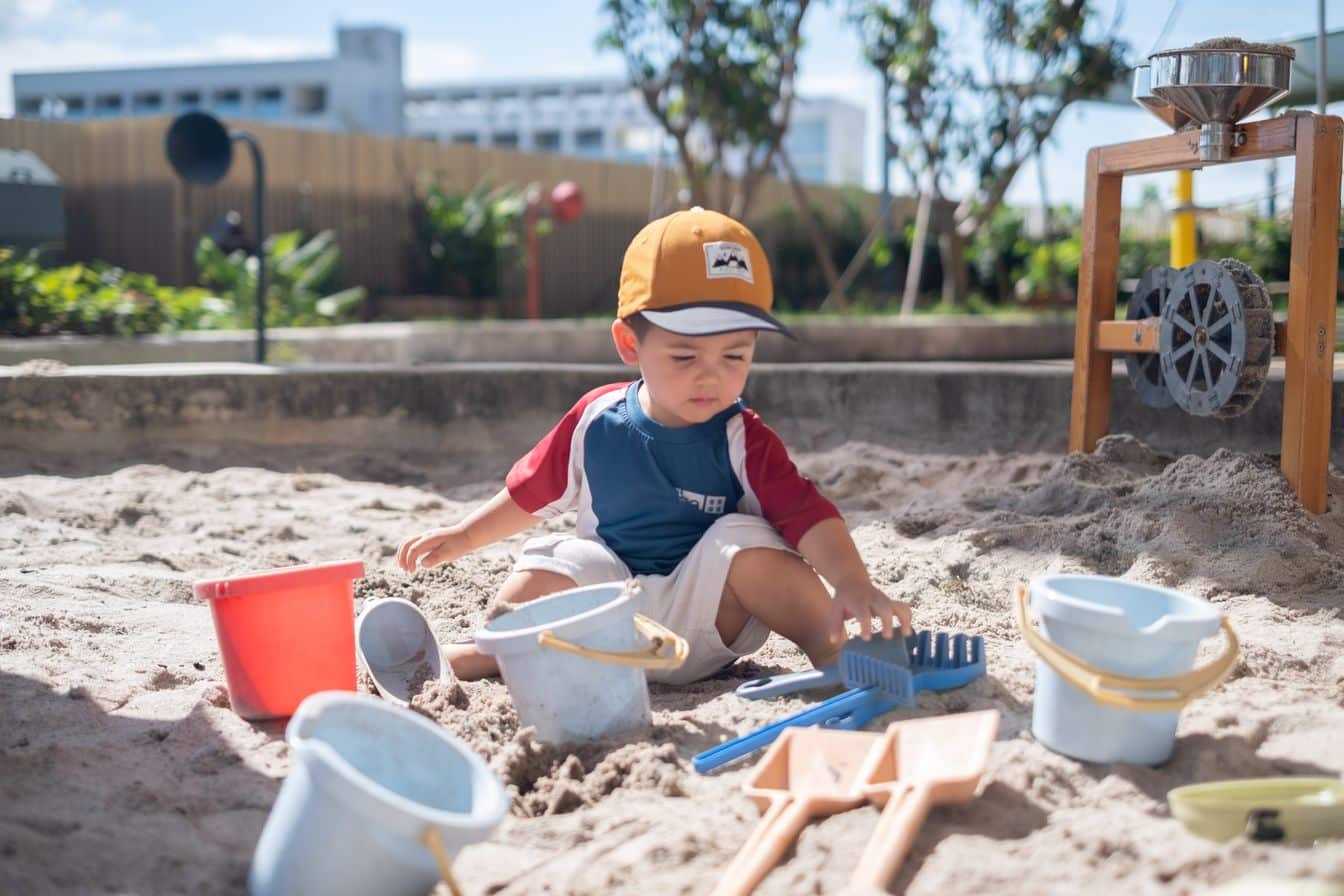 Playgroup image of a kid playing on the sand pool