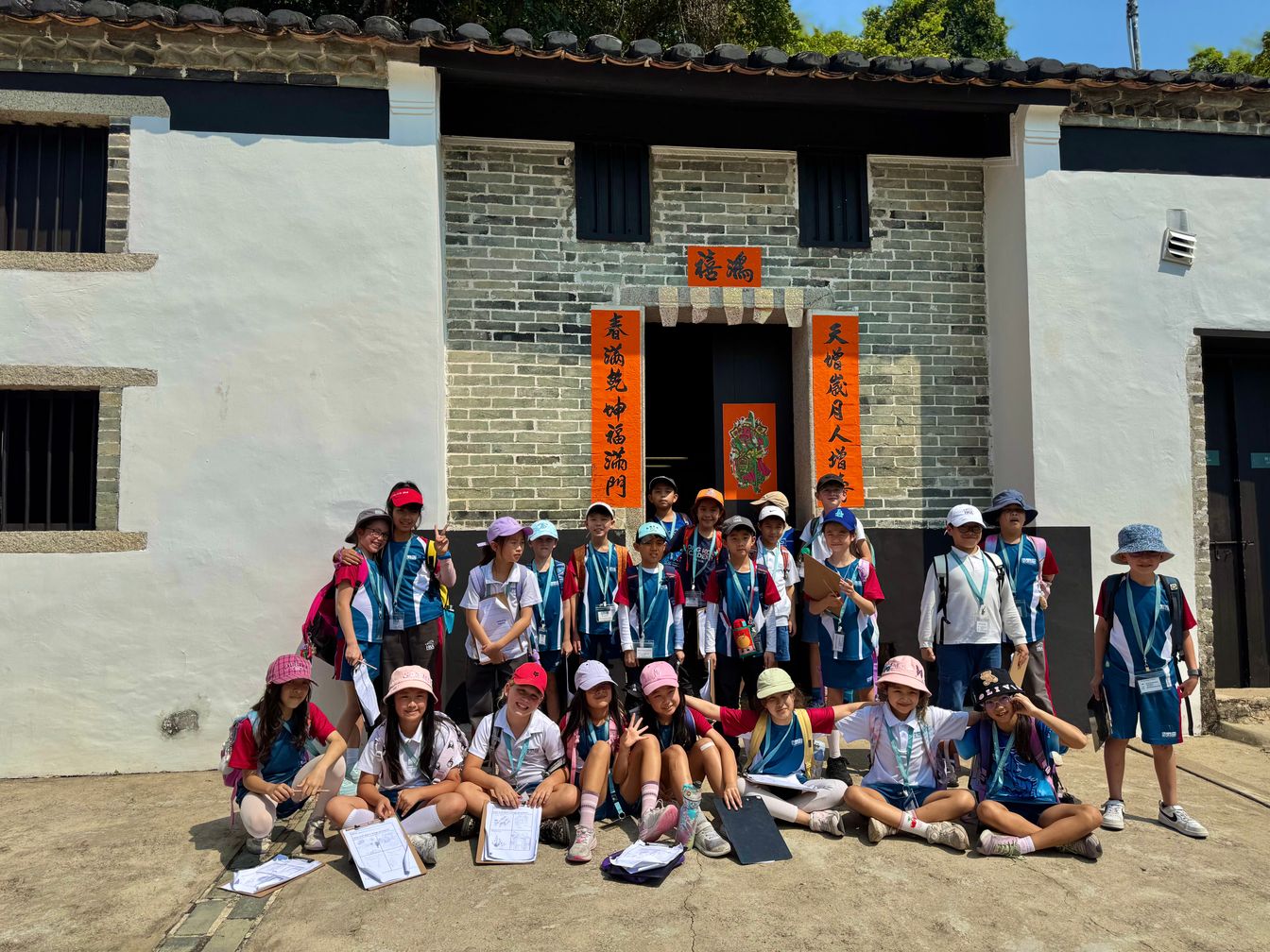 Students group photo in front of a local building