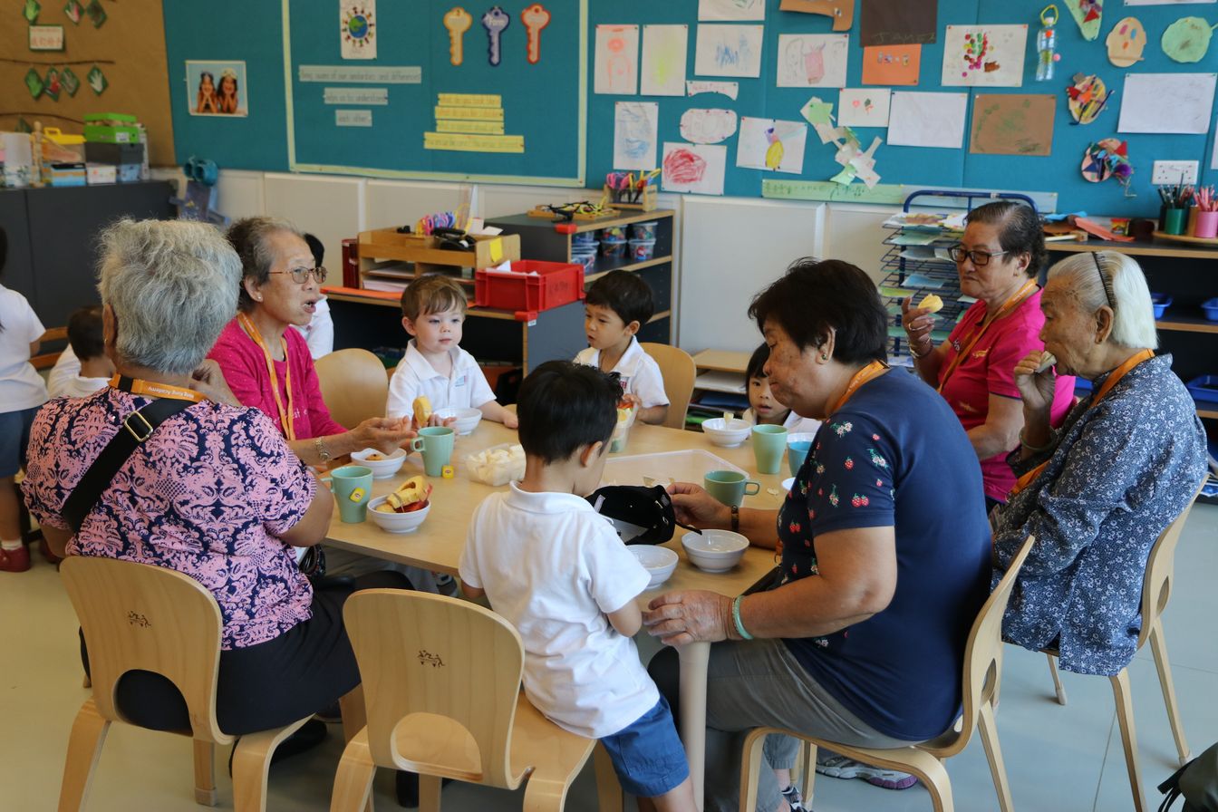 Students are having snacks with elderly